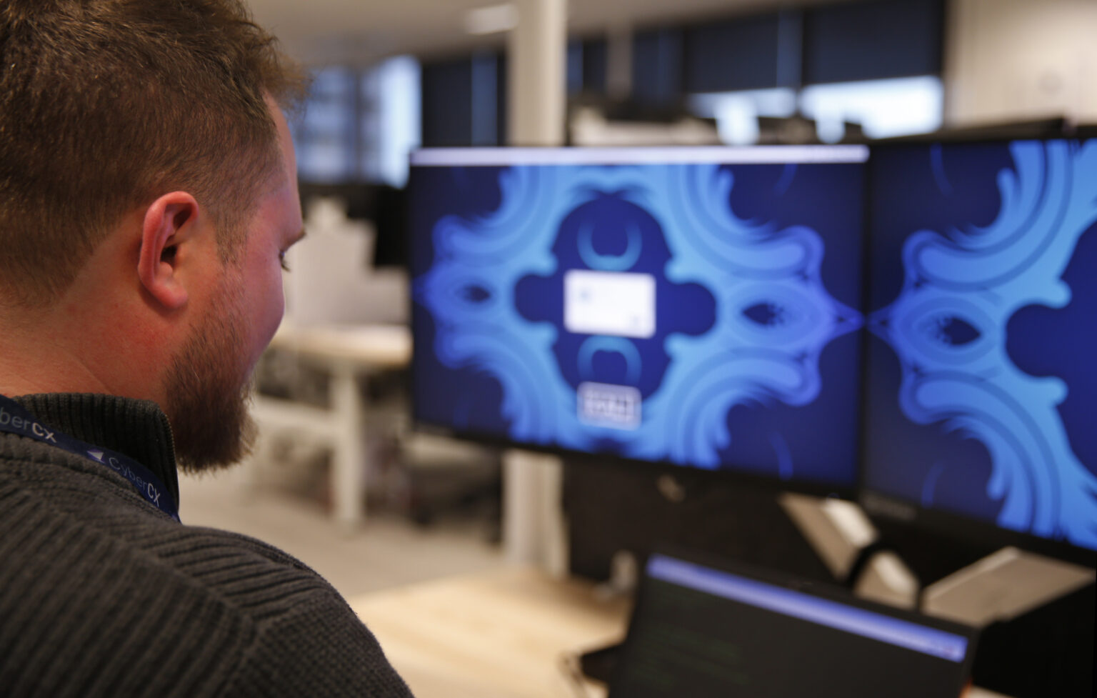 CyberCX security expert working on a computer for vulnerability assessment & management services