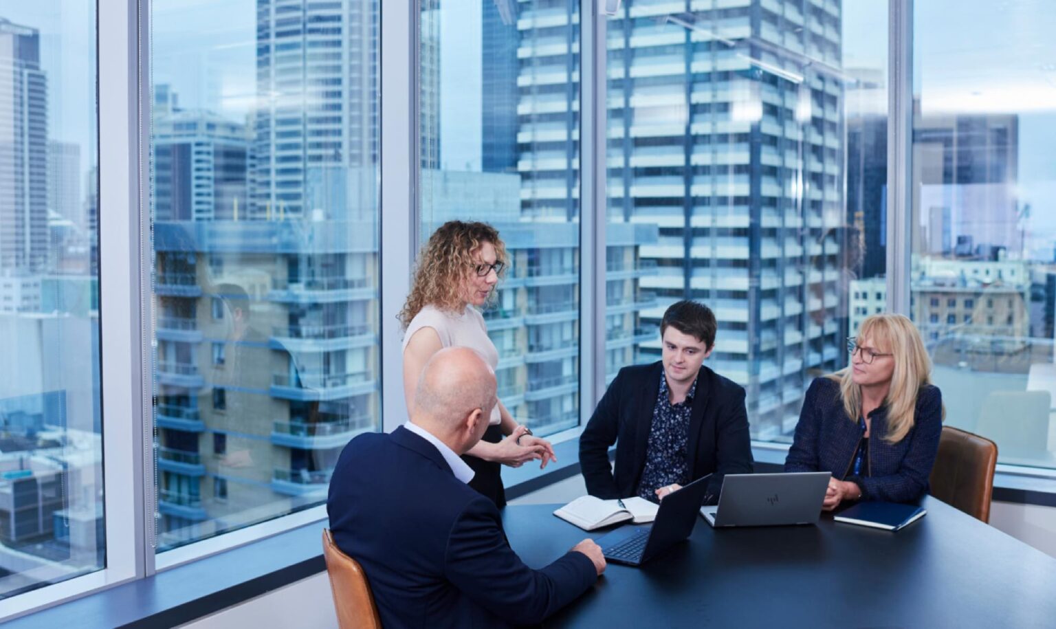 Cyber security team in office building with view of city